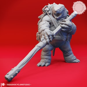 May include: A gray, 3D printed miniature of a turtle-like creature holding a staff. The creature has a backpack and a fierce expression. The miniature is set against a red background.