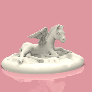 May include: A white ceramic figurine of a winged horse lying down on a cloud-shaped base. The horse has a white mane and tail and is looking to the right.