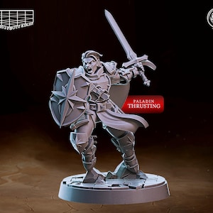 May include: A gray plastic miniature figurine of a paladin holding a sword and shield. The paladin is wearing armor and a cloak. The miniature is standing on a round base. The text "PALADIN THRUSTING" is printed on the base.