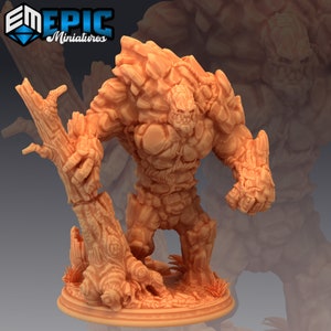 May include: A brown and tan miniature figurine of a stone golem holding a broken tree trunk. The golem is standing on a round base with grass and leaves.