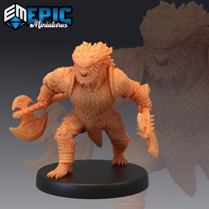 May include: A miniature figurine of a furry, humanoid creature with a fierce expression. The creature is wearing chainmail armour and holding a double-headed axe. The figurine is painted in a light brown colour.