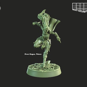 May include: A green plastic miniature figurine of an elven rogue, with long flowing hair, holding a dagger in her right hand. The figurine is standing on a circular base with an intricate design. The text "Elven Rogue, Thiara" is printed below the base.