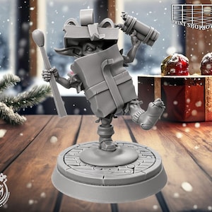 May include: A grey 3D-printed figurine of a Christmas elf holding a match and a cylindrical object. The elf is wearing a gift box as a hat and a gift box as a body. The figurine is on a round base with a wooden texture.