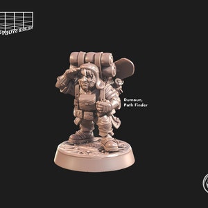 May include: A brown plastic miniature figurine of a dwarf with a backpack, holding a map and looking to the side. The figurine is standing on a round base. The text "Dumoun, Path Finder" is printed below the figurine.