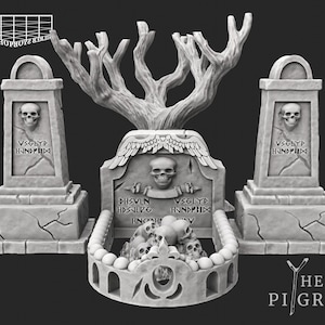 May include: A grey miniature graveyard scene in a gothic style. The scene features two rectangular tombstones with skull carvings and inscriptions, either side of a central tombstone with a tree-like structure. The base has a skull-filled crypt. The text "HE PIGRIM" is visible.