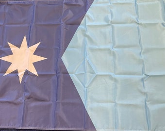May include: A blue and light blue flag with a white eight-pointed star in the upper left corner.