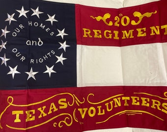 May include: A rectangular flag with a blue canton featuring a circle of 12 white stars and the text "OUR HOMES and OUR RIGHTS". The flag has red and white stripes and gold text that reads "20th REGIMENT" and "TEXAS (VOLUNTEERS)".