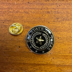 The state of Texas variations of lapel pin hand stamped and baked finished