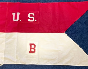 May include: A red, white, and blue flag with the letters "U.S." in white on the red portion and the letter "B" in red on the white portion.