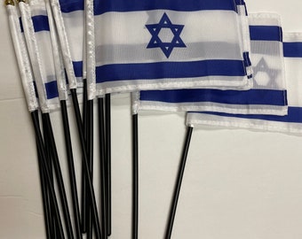 May include: A set of ten small Israeli flags with gold-tipped black plastic poles. Each flag features a blue Star of David on a white background with two blue stripes.