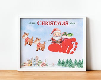 May include: A white frame with a watercolor illustration of Santa Claus in a red sleigh pulled by two reindeer. The sleigh is filled with presents and the text "A Little Christmas Magic" is at the top of the frame.