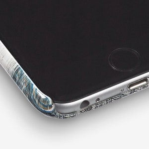 May include: Close-up of a black smartphone case with a white and blue patterned design. The case is made of a durable material and has a sleek, modern look.