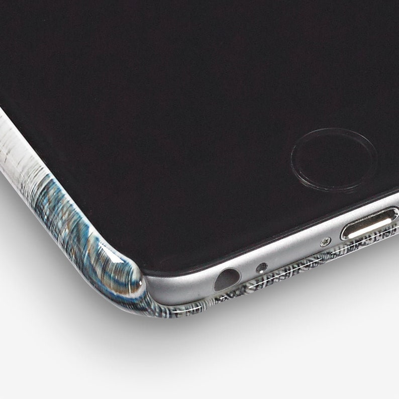 May include: Close-up of a black smartphone case with a white and blue patterned design. The case is made of a durable material and has a sleek, modern look.
