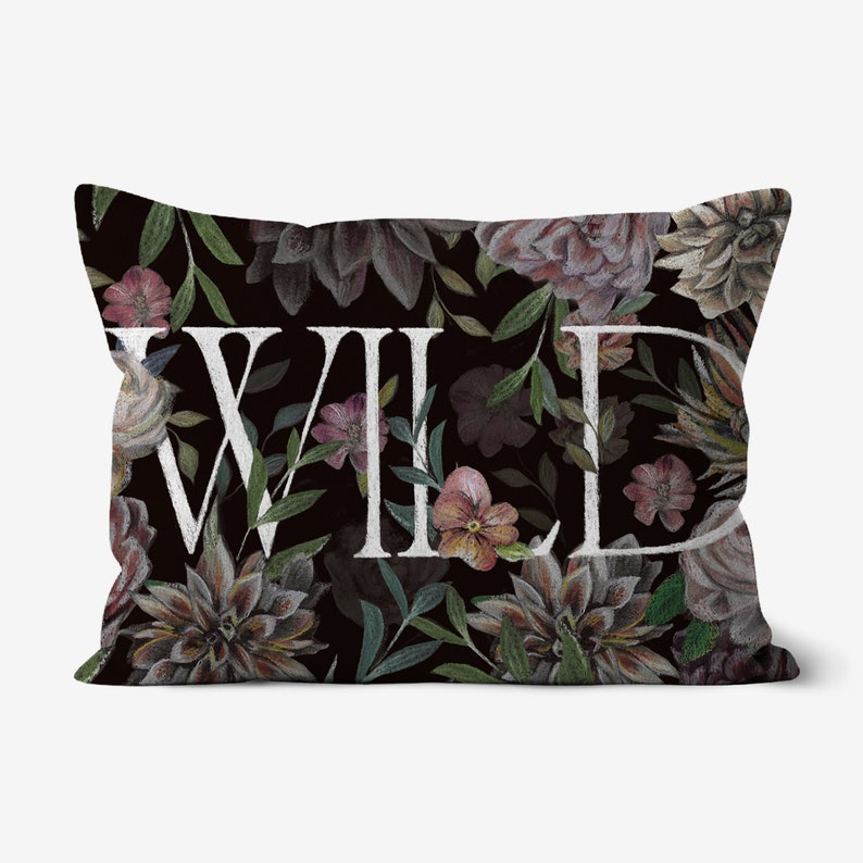 May include: A black pillow with a floral pattern and the word "WILD" in white lettering.
