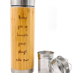May include: A bamboo travel mug with a stainless steel lid and a removable stainless steel infuser. The mug has the words "Never give up because great things take hope" engraved on the side.