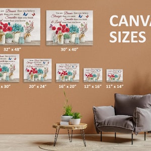 May include: A canvas print with a quote about being brave, stronger, sweeter, and loved. The quote is surrounded by red flowers, butterflies, and mason jars. The image shows different sizes of the canvas print, ranging from 11 inches by 14 inches to 32 inches by 48 inches.