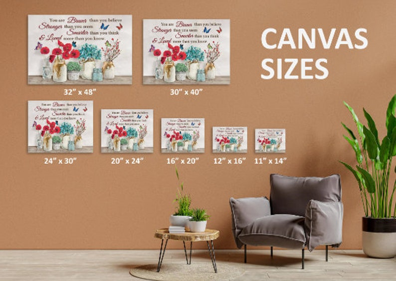 May include: A canvas print with a quote about being brave, stronger, sweeter, and loved. The quote is surrounded by red flowers, butterflies, and mason jars. The image shows different sizes of the canvas print, ranging from 11 inches by 14 inches to 32 inches by 48 inches.
