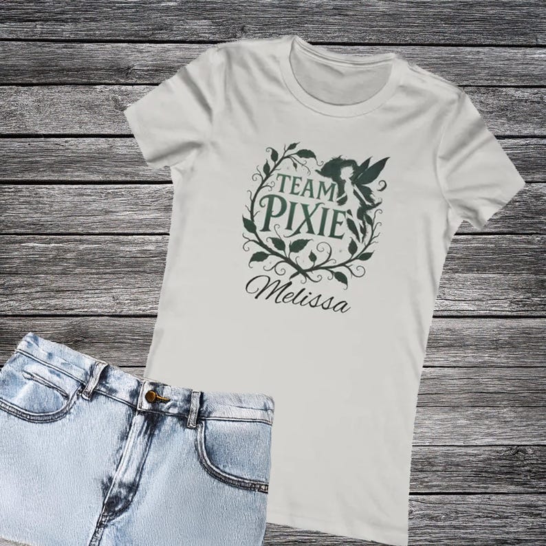 Gray ladies t-shirt with dark team pixie design and name Melissa written underneath the design