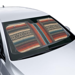 May include: A car windshield sun shade featuring a multi-colored pattern with horizontal stripes in shades of red, orange, cream, black, and teal. The design includes geometric diamond motifs and intricate linear details across the entire surface.