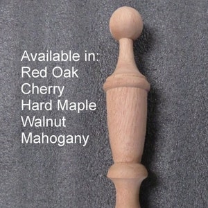 May include: A wooden finial with a rounded top and a fluted design. Available in Red Oak, Cherry, Hard Maple, Walnut, and Mahogany.