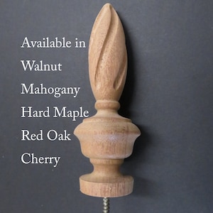 May include: A wooden finial with a spiral design, available in walnut, mahogany, hard maple, red oak, and cherry.
