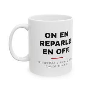 May include: A white ceramic mug featuring the black text ON EN REPARLE EN OFF. with a red horizontal line underneath, followed by the smaller italicized text (Traduction : il n'y aura aucune trace.) printed on the front surface.