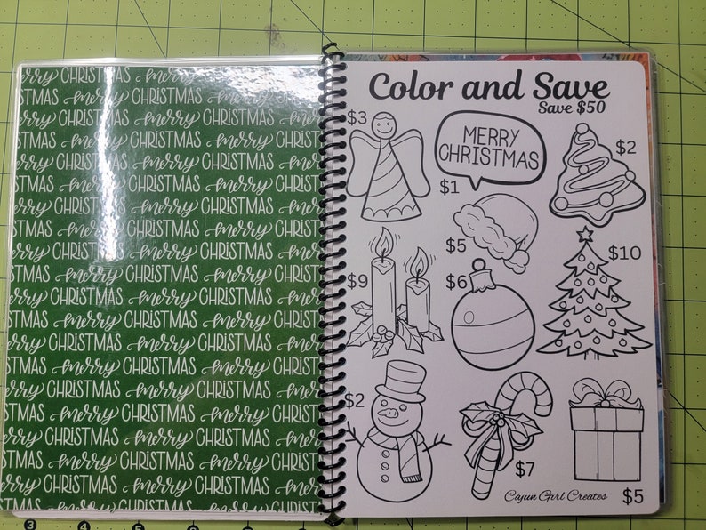 May include: A page from a coloring book with the title "Color and Save" and the text "Save $50". The page features black and white illustrations of Christmas-themed images, including an angel, candles, a Christmas tree, a Santa hat, an ornament, a snowman, a candy cane, and a gift box. Each image has a price listed next to it.