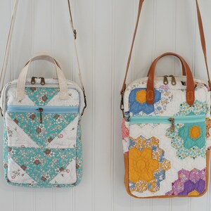 May include: Two quilted crossbody bags with floral patterns and zip closures. One bag features a teal and white floral design, while the other showcases a patchwork of colorful floral fabrics. Both have top handles and adjustable straps.
