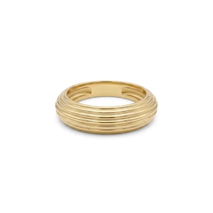 May include: A polished gold ring featuring a rounded, domed profile with a series of horizontal, parallel grooves encircling the entire band. The metal has a reflective, smooth finish, creating a consistent, uniform appearance throughout the piece.