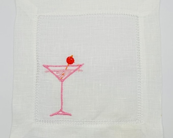 May include: White linen cocktail napkin with pink embroidered martini glass and a red cherry.