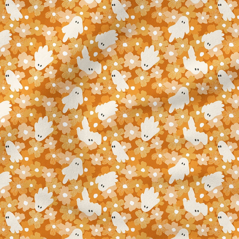 May include: A fabric pattern featuring a repeating design of small white ghosts with simple black oval eyes scattered across a background of orange and light yellow flowers with white centers. The textile has a visible woven texture throughout.