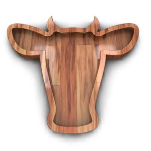K&ouml;nnte beinhalten: Ein h&ouml;lzerner Kuhkopf-Ausschnitt mit einer nat&uuml;rlichen Holzmaserung. Der Ausschnitt ist hohl und wirft einen Schatten auf einen wei&szlig;en Hintergrund.