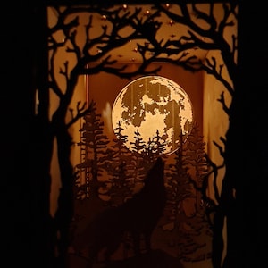 May include: A wooden silhouette of a wolf howling at the moon in a forest setting. The moon is full and illuminated, casting a warm glow on the scene. The wolf is silhouetted against the moon, and the trees are silhouetted against the moon and the wolf.