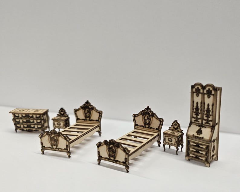 May include: A set of miniature wooden bedroom furniture, comprising two beds, a chest of drawers, two bedside tables, and a tall cabinet. The furniture has intricate detailing and a light brown finish, ideal for dollhouses or crafts.