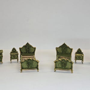 May include: A miniature bedroom suite in a classic style. The set includes a chest of drawers, two bedside tables, two beds, and a wardrobe. The furniture is painted green with gold accents.