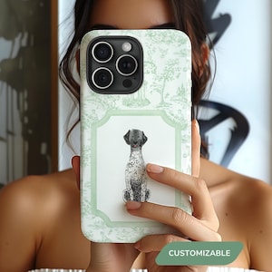 May include: A white iPhone case with a green and white floral pattern and a black and white illustration of a dog. The case has a cutout for the camera lens and a text overlay that says "CUSTOMIZABLE".