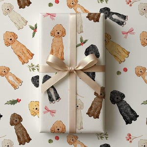 May include: A rectangular gift box wrapped in white paper featuring a repeating watercolor pattern of various poodles in shades of brown, black, and cream, interspersed with small red berries, green holly leaves, and pink bows, tied with a beige ribbon.