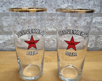 2 vintage Heineken HBM beer glasses with gold rim.