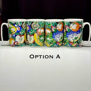 May include: Four white ceramic mugs with a colorful fruit design. The mugs feature a variety of fruits, including apples, bananas, oranges, and pineapples. The mugs are arranged in a row, with the handles facing the right.