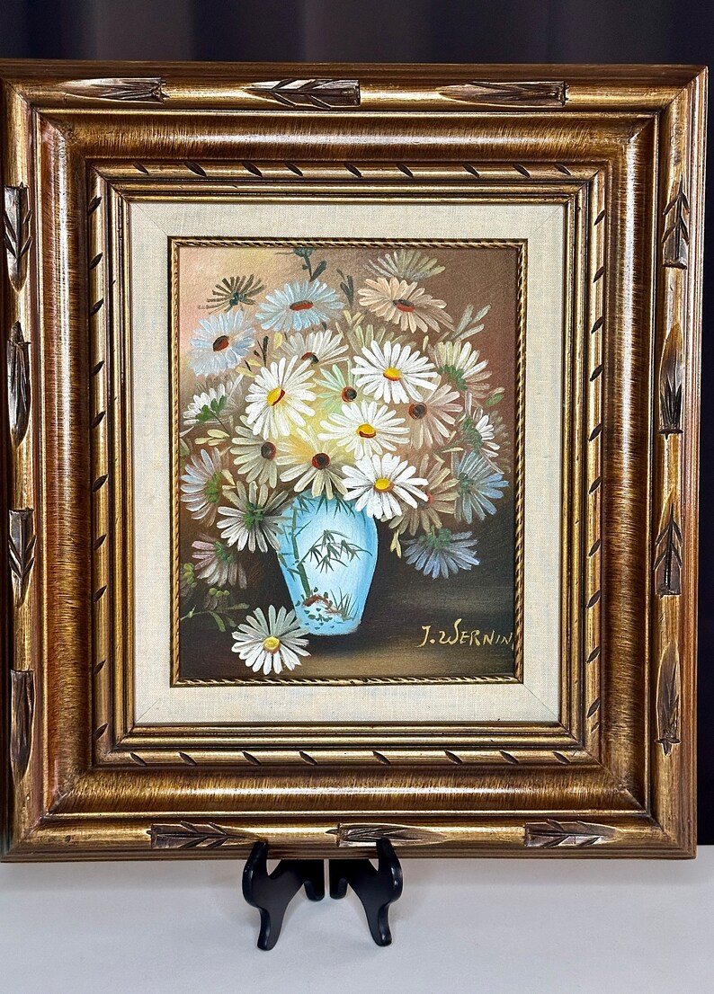 May include: A framed painting of a bouquet of white daisies in a blue and white vase with a bamboo design. The painting is signed "J.Z.Wernin".