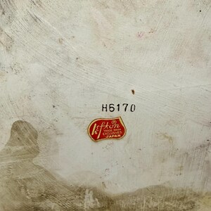 May include: A close-up of a vintage ceramic piece with a textured, off-white surface. The number "H6170" is printed in black. A red and gold "Lefton" sticker is affixed, indicating "Trade Mark Exclusives Japan".