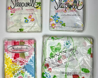 May include: Four packages of bedding, all featuring floral patterns and the words "Irregulars" and "No Iron". The packages are labeled "Sleepwell", "Meadowbrook", and "Cannon".