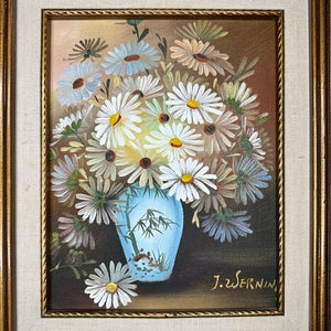 May include: A framed painting of a bouquet of white daisies in a blue and white vase with a bamboo design. The painting is signed "J.Wernin" in the lower right corner.