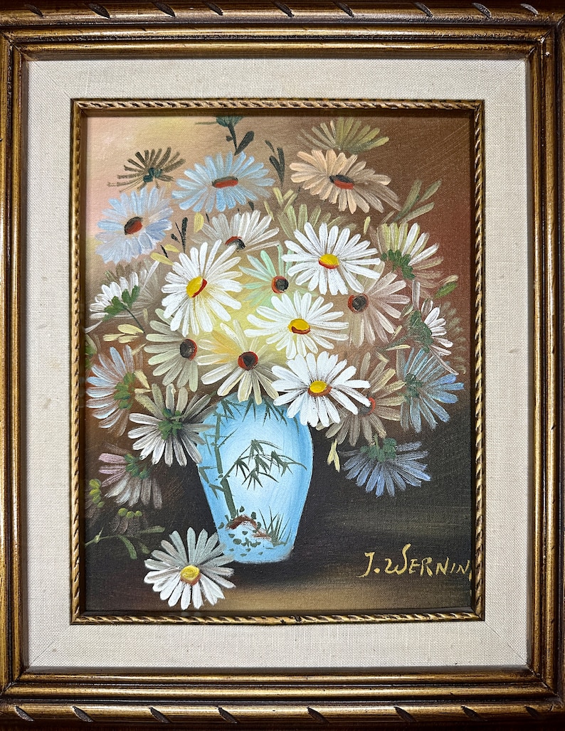 May include: A framed painting of a bouquet of white daisies in a blue and white vase with a bamboo design. The painting is signed "J.Wernin" in the lower right corner.