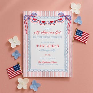 May include: A patriotic birthday party invitation with the text "Our All American Girl is Turning Three!" in red and blue. The invitation is decorated with red, white, and blue bunting and American flags. White and blue flowers are scattered around the invitation.