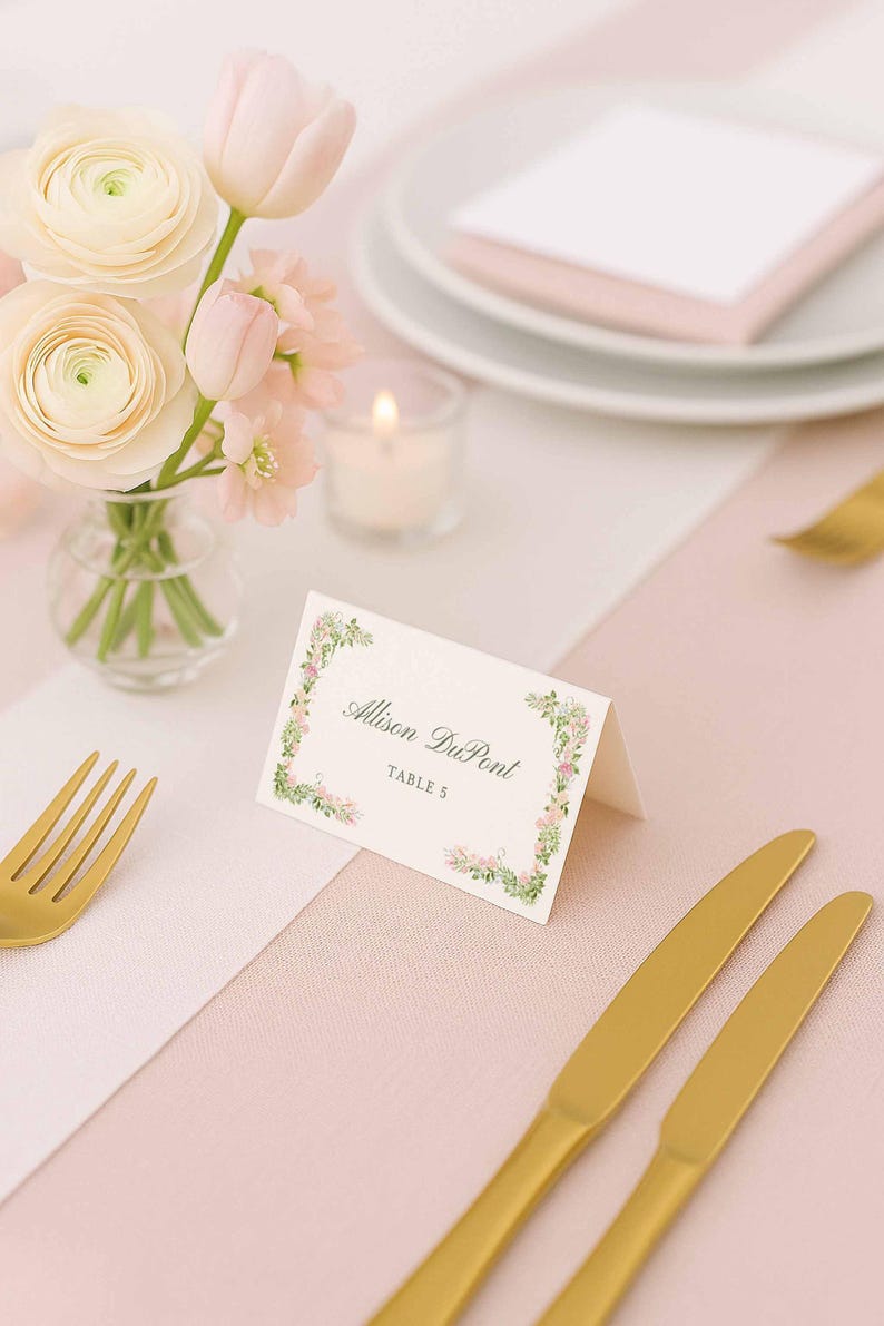Editable floral place card displayed beside delicate wedding florals and soft candlelight.