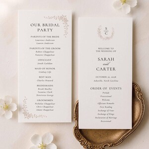 May include: Two white rectangular wedding programme cards with black serif text and light brown floral accents. One card lists the bridal party, while the other displays the wedding details for Sarah and Carter, including the date 16 October 2028.