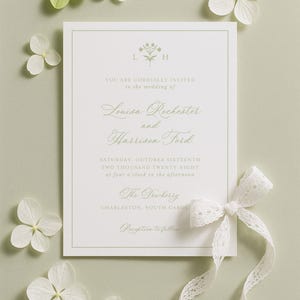 The image is a wedding invitation card with a white background, surrounded by white flowers and a white ribbon.