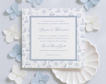May include: A square rehearsal dinner invitation card featuring a blue and white nautical pattern of sailboats, lighthouses, and seashells. The text reads: Please join us for a rehearsal dinner honoring Louisa & Harrison, Friday, October fifteenth, two thousand twenty-eight at six o'clock in the evening, Beach House Grill, Chatham, Massachusetts, Cocktail Attire.