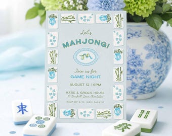May include: A light blue invitation card with the text "Let's Mahjong!" and game details, surrounded by decorative tiles. The card is set on a light blue surface with scattered confetti, alongside Mahjong tiles and a vase of blue and green flowers.
